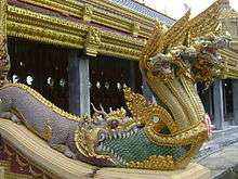Naga emerging from the mouth of a Makara in the style of a Chinese 