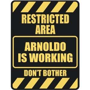   RESTRICTED AREA ARNOLDO IS WORKING  PARKING SIGN