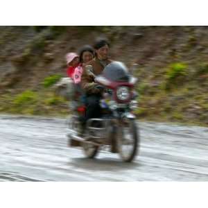 Tibetan Family Traveling on Motorbike in the Mountains, East Himalayas 