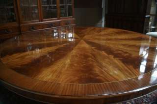 Large round mahogany table shown with 10 Chippendale chairs.