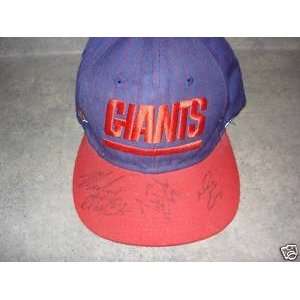   , Michael Strahan, and Dave Brown Autographed NY Giants hat w/ COA